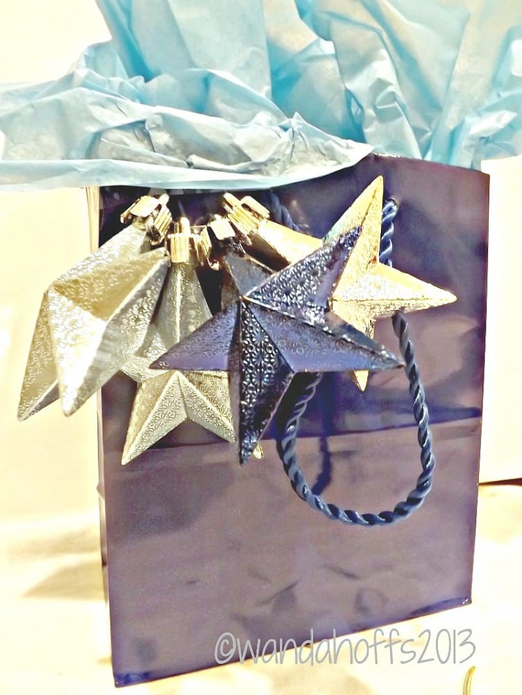Use ornaments to dress up gift bags for Christmas