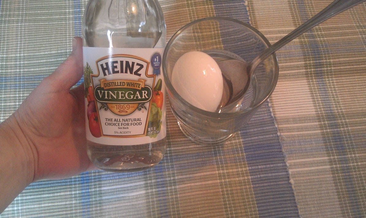 The first step to making tie dye Easter eggs is to soak the boiled eggs in vinegar