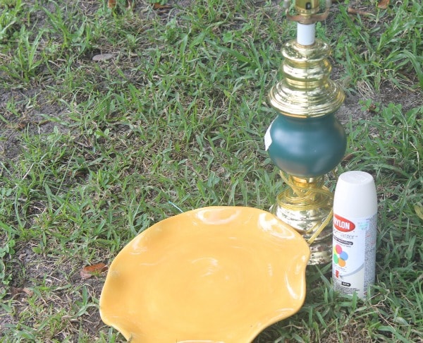 Items needed to make a sunflower bird feeder from an old lamp and plate.