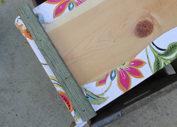 Attaching top to crate to make an ottoman.