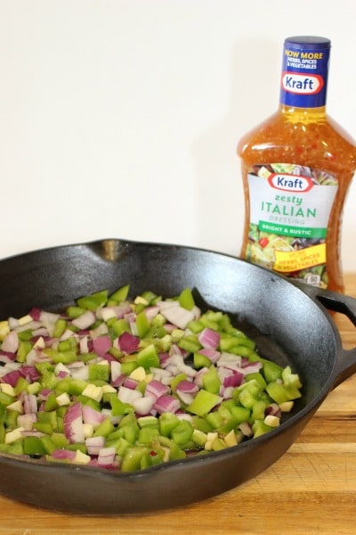 sauteing onions and peppers in Kraft Zesty Italian dressing for Zesty Skillet Ratatouille Recipe