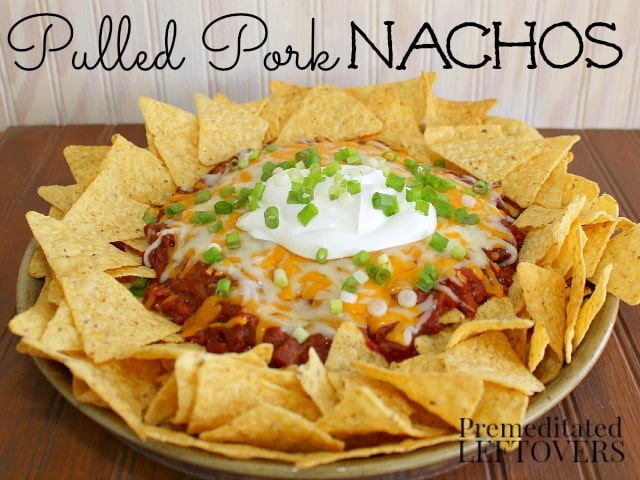 Pulled Pork Nachos topped with cheese, sour cream and green onions.
