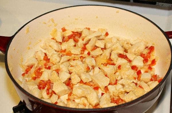 Saute chicken, red pepper, onion, and garlic for Chicken and Red Pepper Pasta Skillet Recipe with Spinach