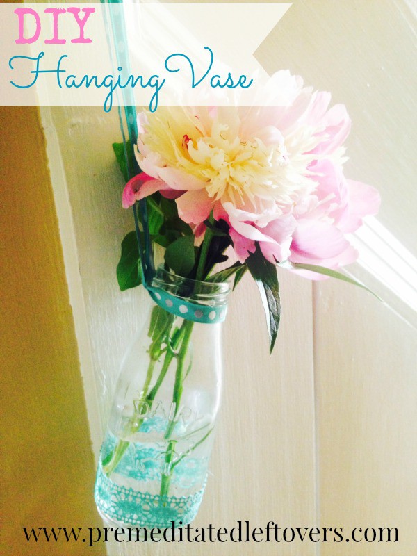 DIY Hanging Milk Bottle Vase - A step-by-step tutorial for making a DIY hanging milk bottle vase with a ribbon hanger and accents.