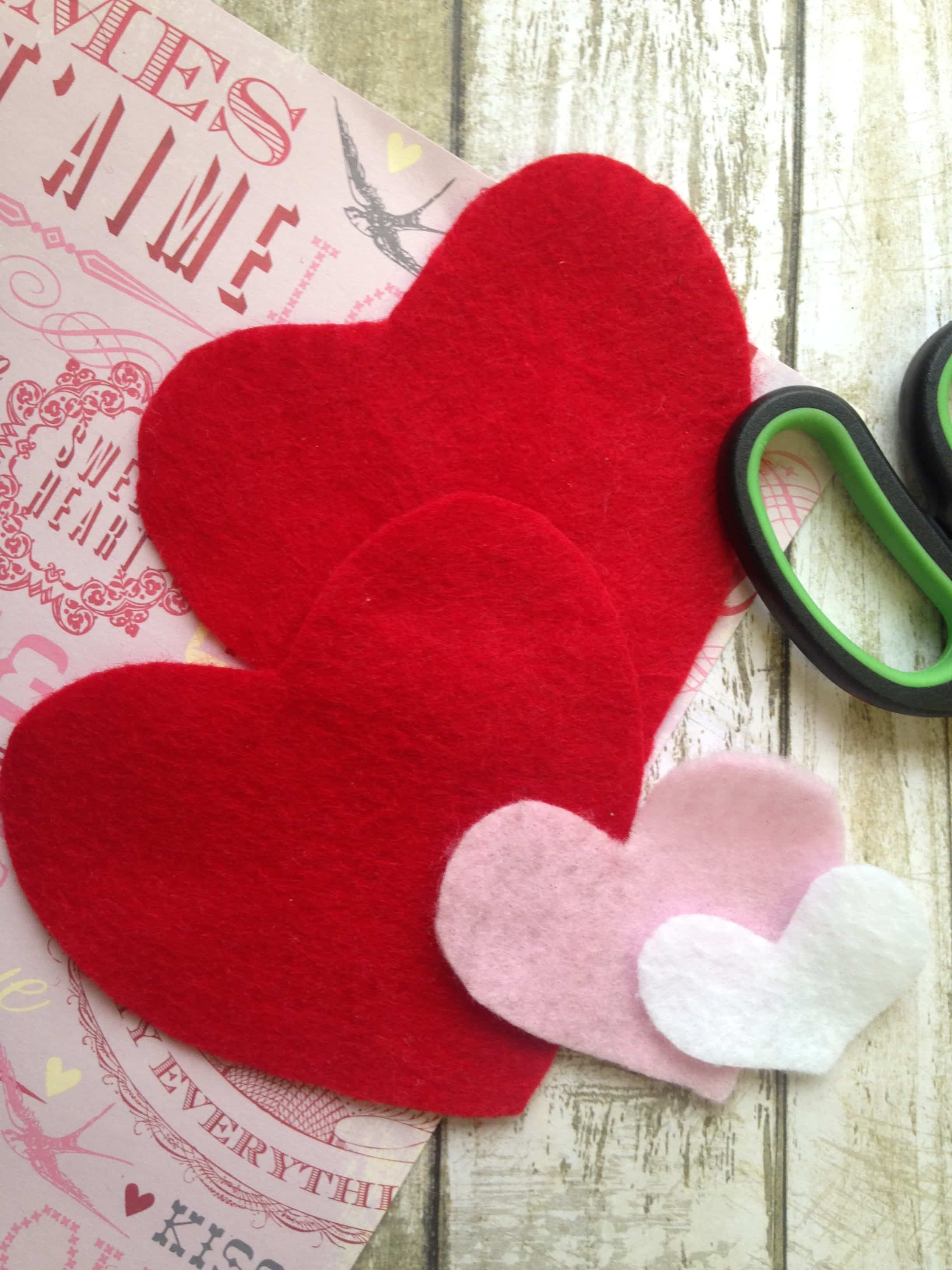 Cut felt hearts from 3 different colors of felt to make this essential oil scented Felt Heart Sachet 