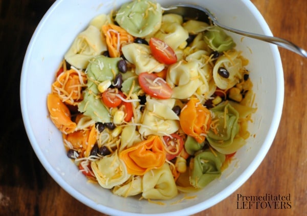 Gently stir the ingredients for the Southwest Ranch Tortellini Salad recipe
