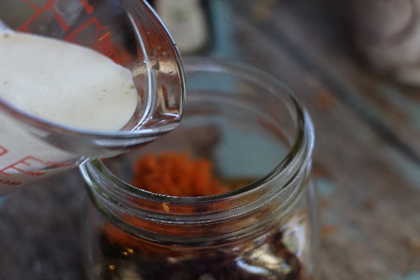 Carrot Cake Overnight Oatmeal- Pouring coconut milk