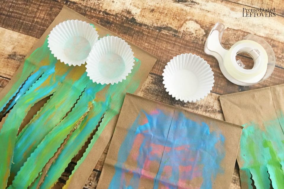 Paper Bag Jellyfish Craft - taping cupcake liners to painted bags
