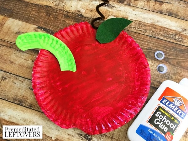 paper plate apple craft for kids- glue on googly eyes
