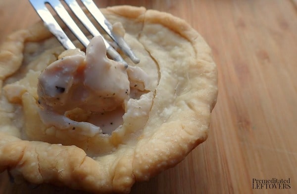 Chicken Alfredo Mini Pot Pie Recipe- fork in baked pot pie