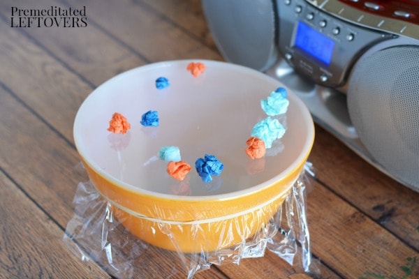 Sound and Volume Vibrations Science Experiment- place balls on plastic wrap