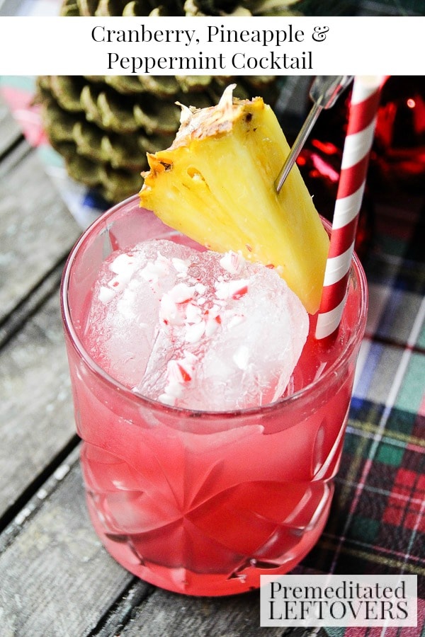 Raise a glass of Christmas cheer! This simple Cranberry, Pineapple, and Peppermint Cocktail recipe is garnished with crushed candy cane and pineapple. 