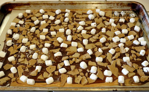 Top melted chocolate with mini marshmallows and broken graham crackers pieces