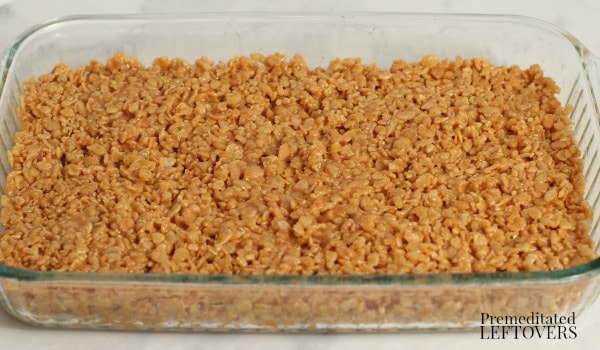The peanut butter rice krispy treats pressed into a 9 x 13 dish.