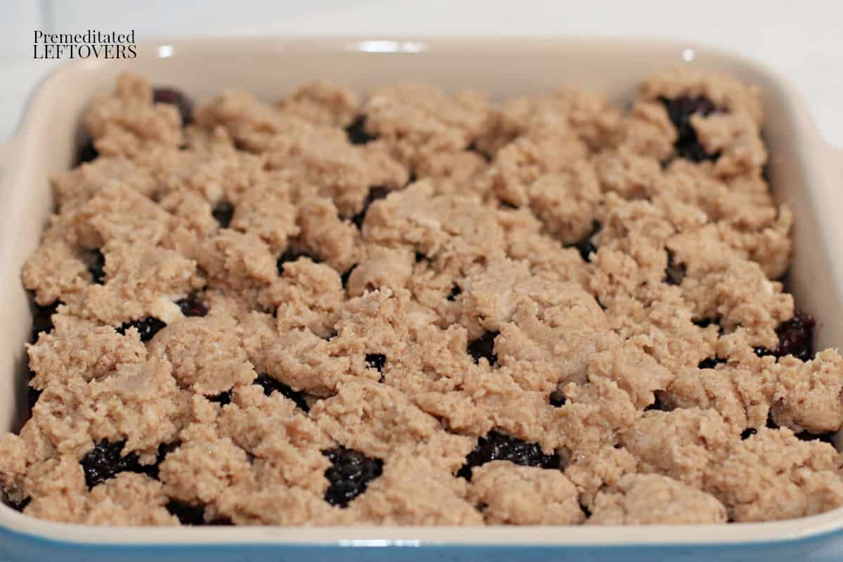 cobbler dough spooned on top of blackberries