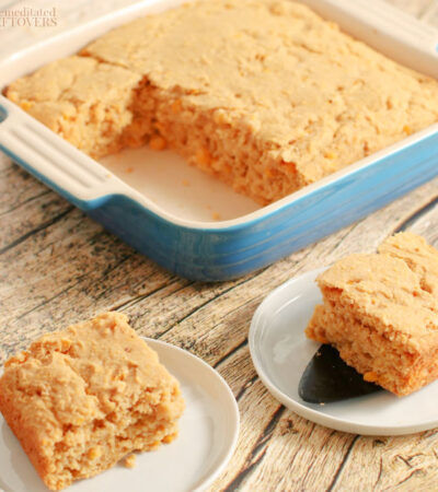 cornbread casserole recipe in baking dish and a slice of corn casserole on a plate