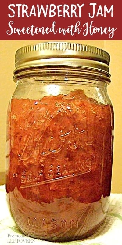 Mason jar with strawberry jam in it.