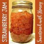 Strawberry jam sweetened with honey canned in 16 oz mason jar.