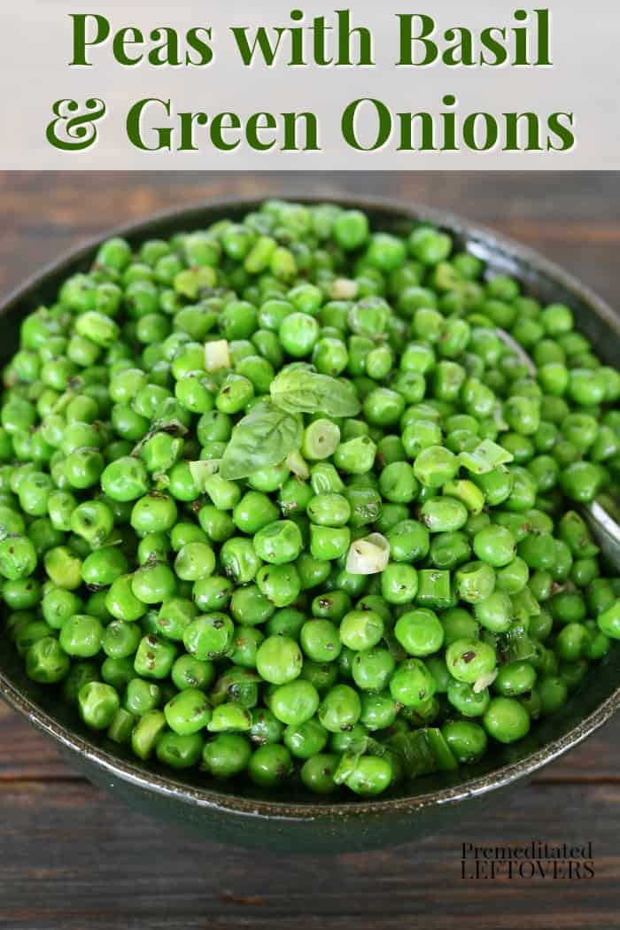 Peas with green onions and basil in a serving bowl.