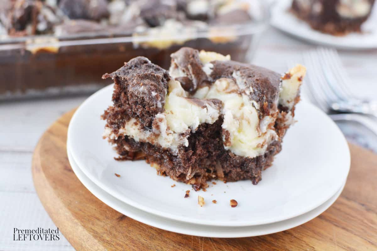 A slice of earthquake cake on a white plate.