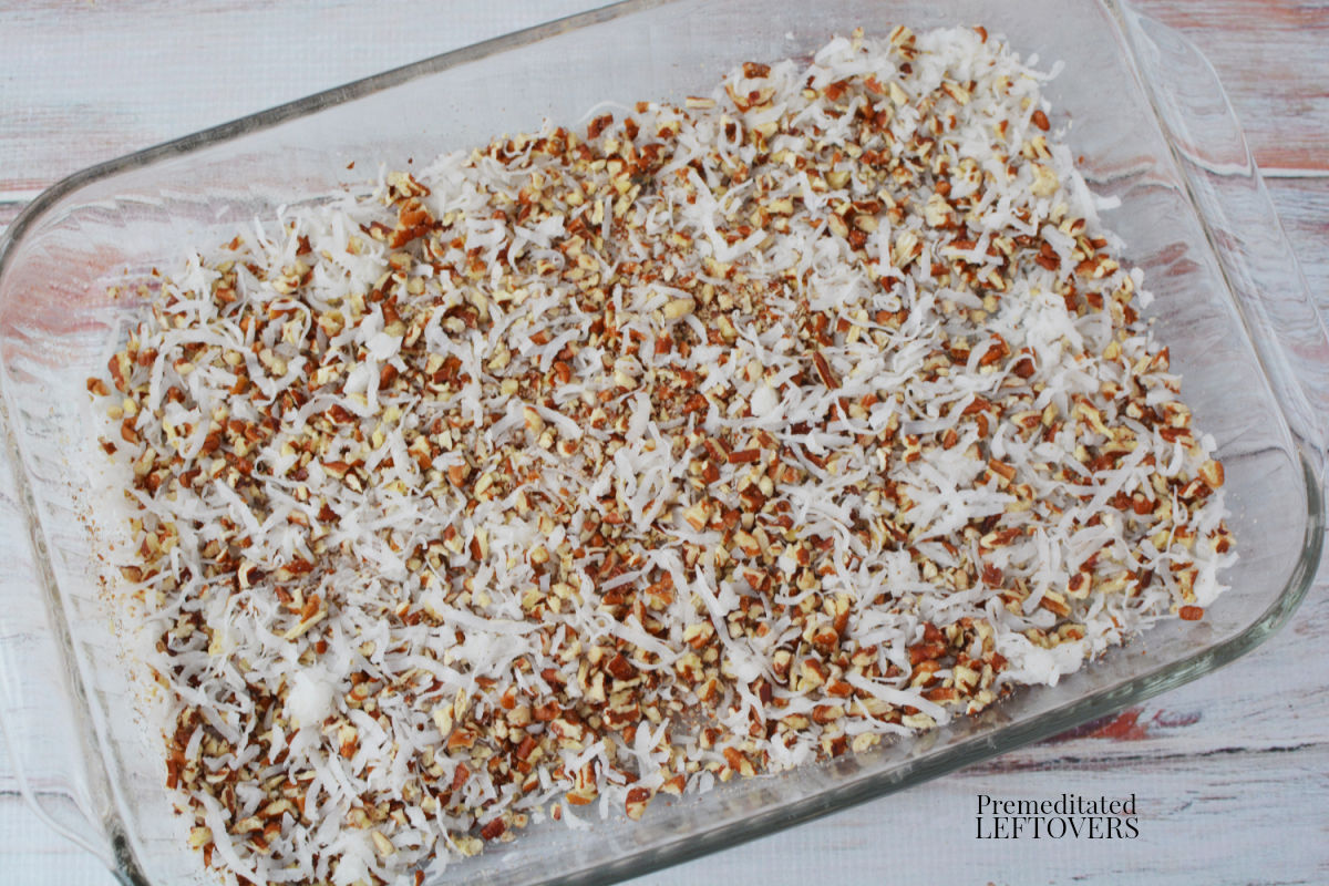 Place the shredded coconut and chopped pecans on the bottom of the cake pan.