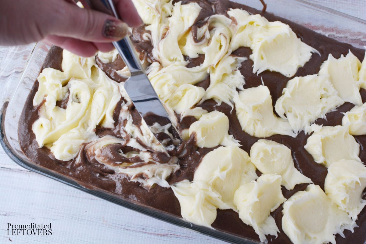 Use a knife to cut the cream cheese mixture into the cake mix..