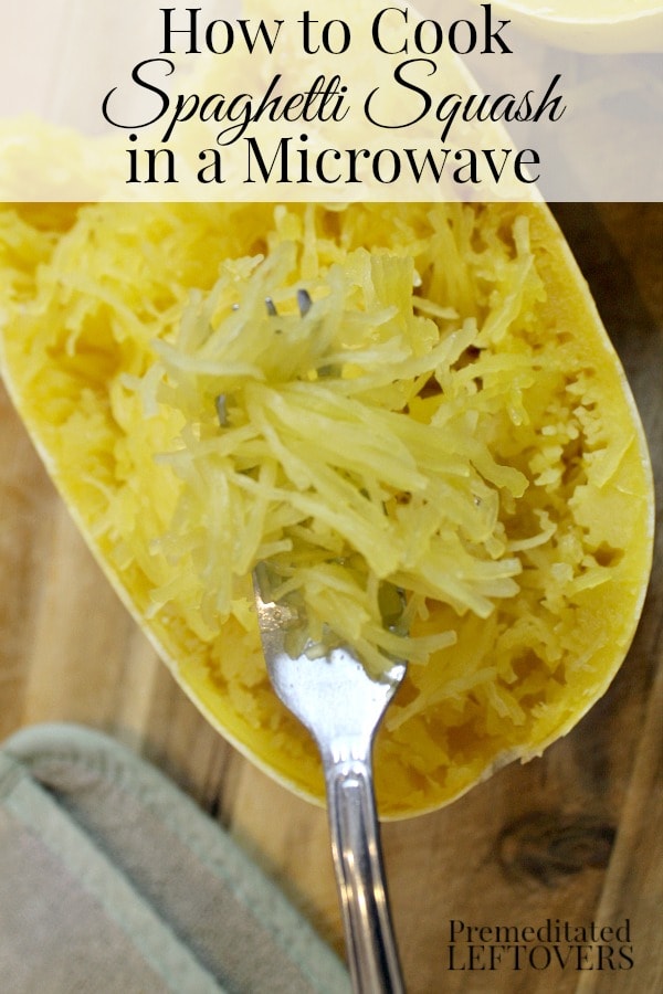 Microwave Spaghetti Squash with a fork separating the squash strands.