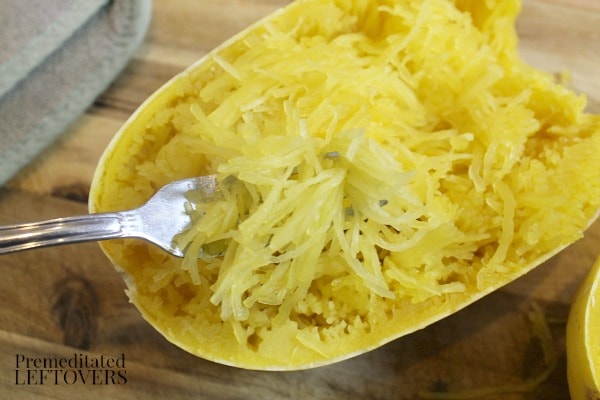 Use a fork to loosen the squash strands. Then pull the spaghetti-like strand out of the squash.