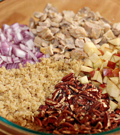 ingredients for quinoa salad recipe with chicken in a large bowl