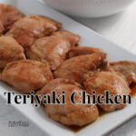 Teriyaki chicken on a white platter.