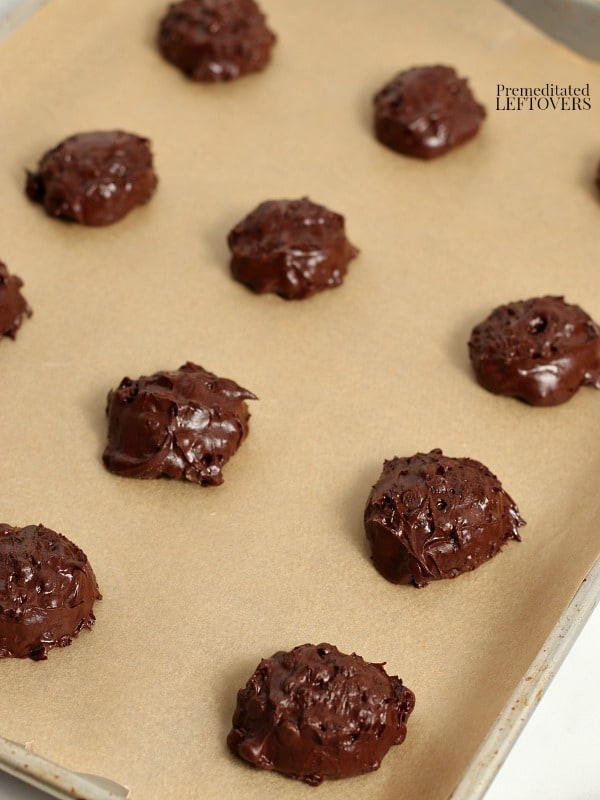 spoonfuls of flourless chocolate cookie dough on a cookie sheet