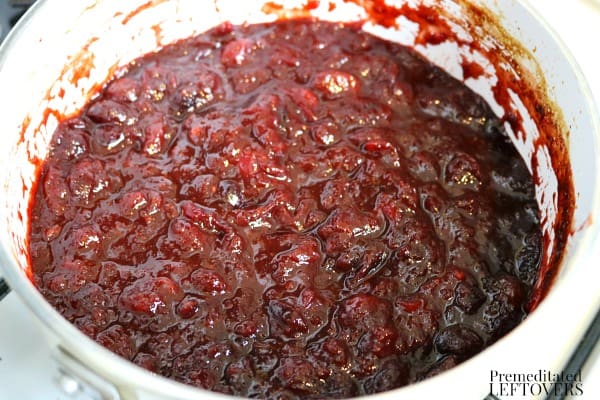 Simmer the homemade cranberry sauce in pot for 20 minutes.
