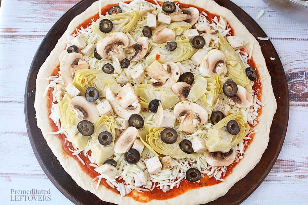 Pizza with toppings added, ready to cook
