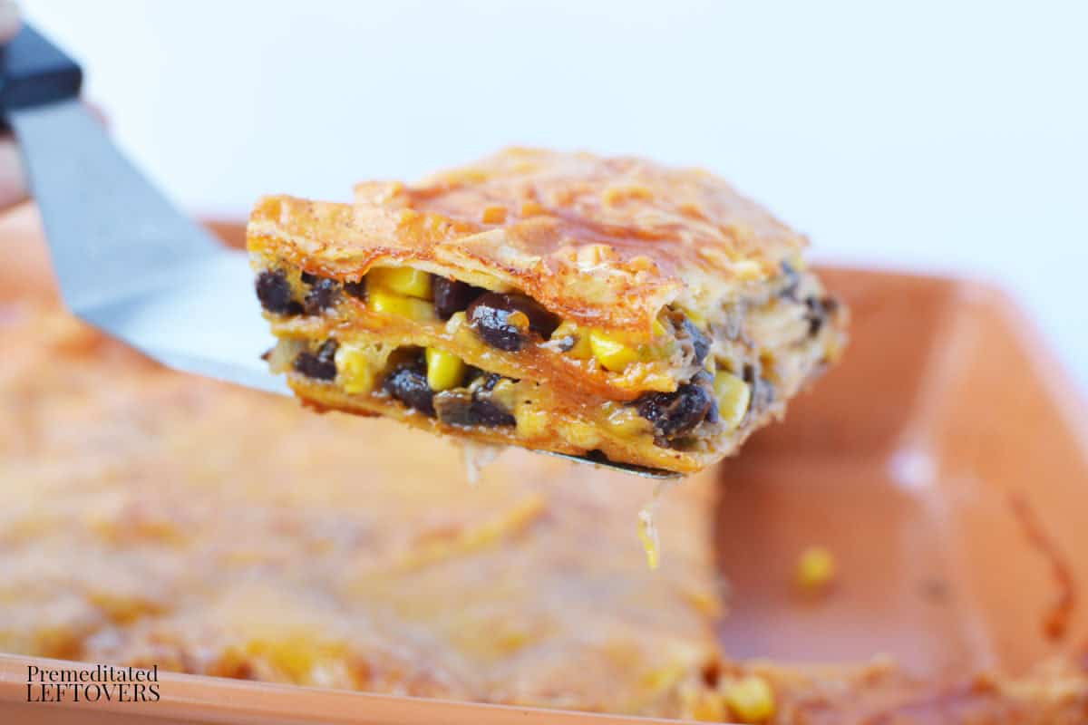 a slice of mushroom and black bean casserole being served