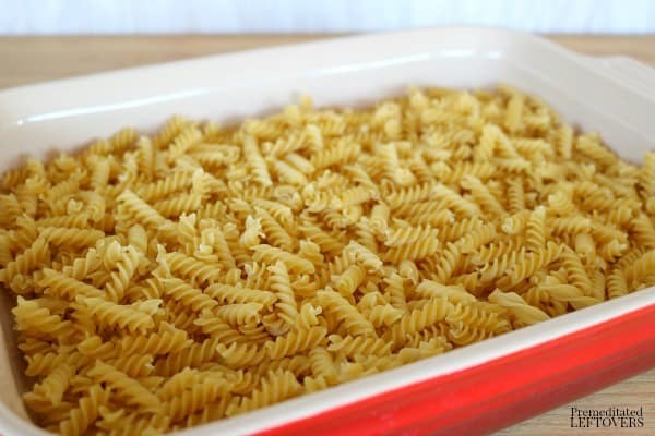 First layer rotini noodles in bottom of the casserole dish.