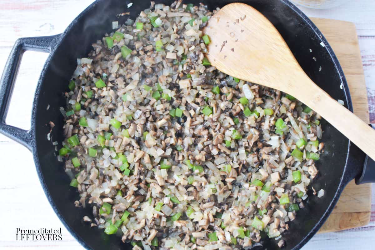 sauteed mushrooms, onion, and bell pepper in a cast iron skillet