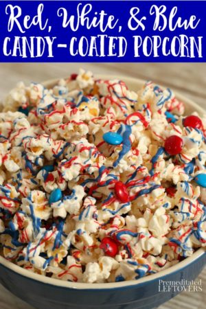 red, white, and blue candy-coated popcorn topped with red and blue M&Ms in a blue bowl
