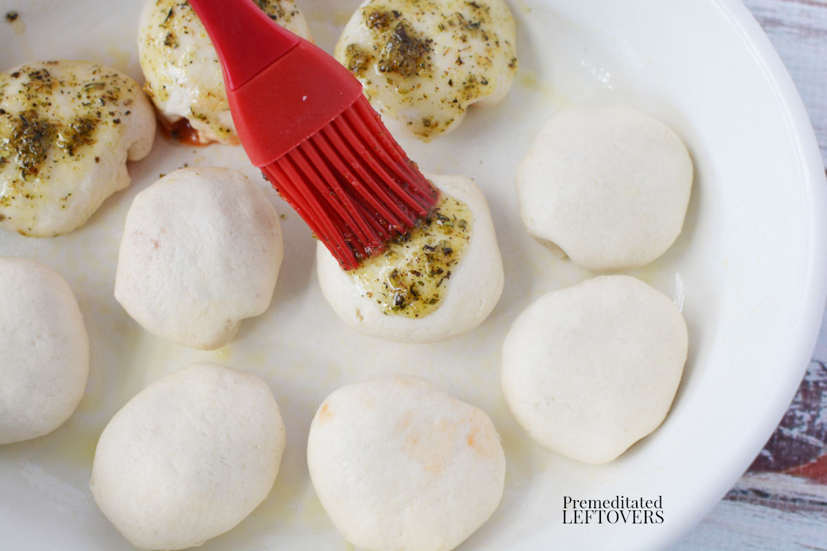 Brush pizza pockets with garlic butter