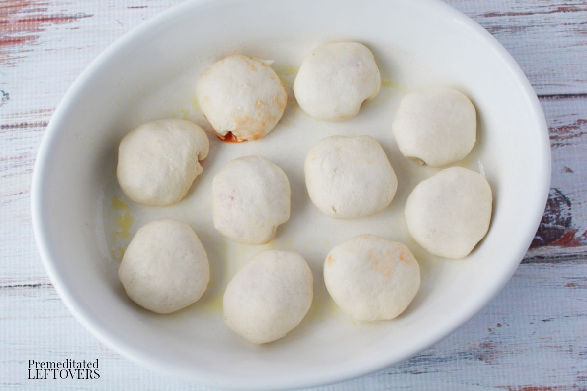 place the pizza snack rolls in a greased baking dish