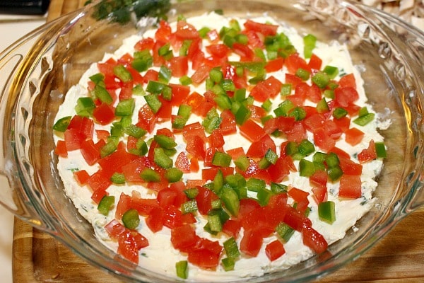 Layering ingredients for pizza dip recipe 