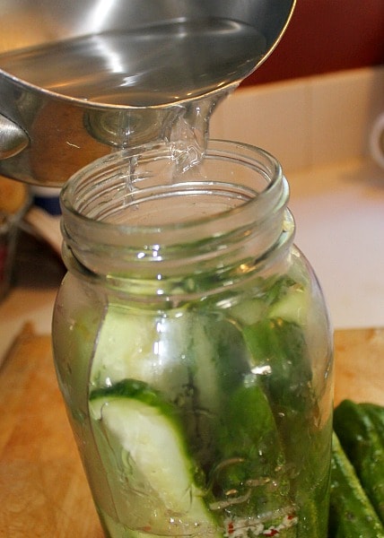 Pour liquid over the cucumbers - easy refrigerator pickles recipe