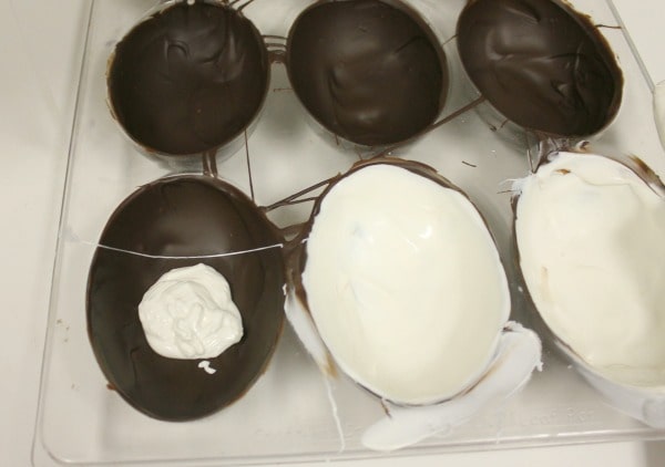 Adding white chocolate layer to the inside of hollow chocolate eggs - messy business