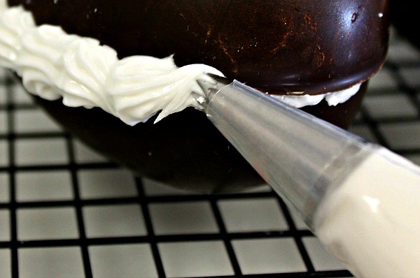 Pipe royal icing around the seam on the hollow chocolate eggs