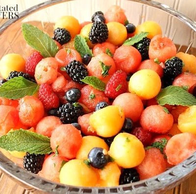 Mojito Fruit Salad: Watermelon & Berry Salad with Mint-Lime Dressing - A ruit salad made of watermelon, cantaloupe, and berries flavored with mint and lime.