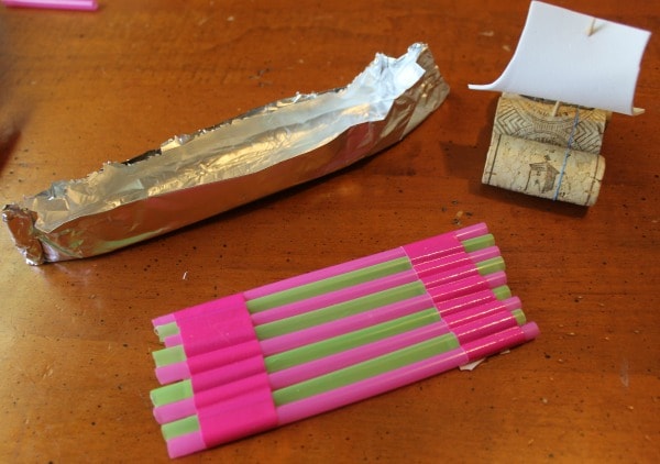 making toy boats that float using wine corks, foil, and straws