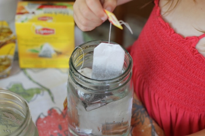 How to make sun tea: placing tea bags in mason jar