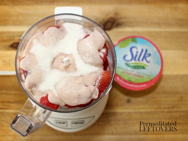 Place Silk Dairy-Free Yogurt Alternative, frozen strawberries, and sugar in a food processor to make dairy-free frozen yogurt recipe