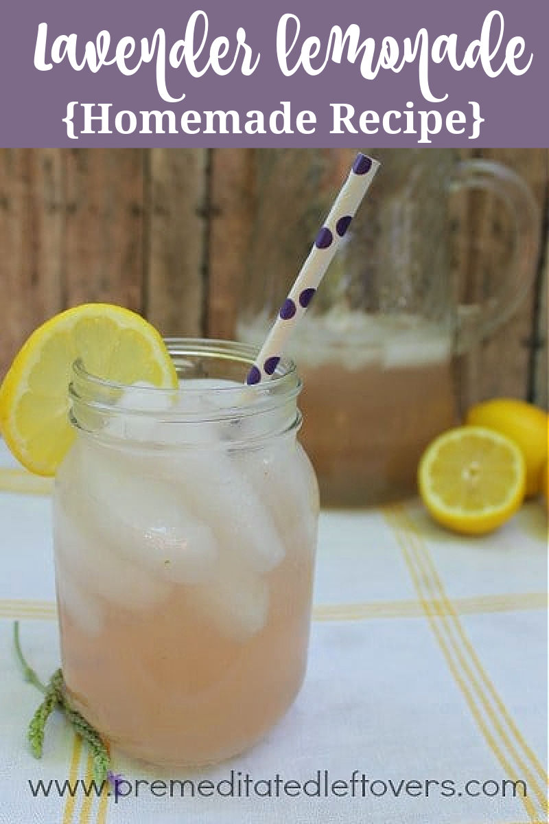 homemade lavender lemonade recipe in a glass mason jar with a straw and a slice of lemon