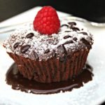 Chocolate Raspberry Lava Cake- Here is an easy and decadent dessert everyone will love. This Lava Cake is dripping with chocolate and topped with raspberry.