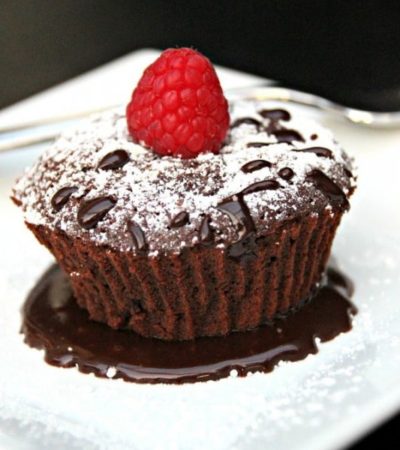 Chocolate Raspberry Lava Cake- Here is an easy and decadent dessert everyone will love. This Lava Cake is dripping with chocolate and topped with raspberry.